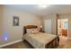 Cozy bedroom features soft lighting, neutral color palette, and access to the ensuite bathroom at 3202 Lucky Pl, Conyers, GA 30013