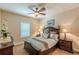 Comfortable bedroom featuring a ceiling fan, carpet, and large decorative lamps at 3202 Lucky Pl, Conyers, GA 30013