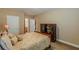 Bedroom features neutral color palette, access to ensuite bathroom and decorative cabinet at 3202 Lucky Pl, Conyers, GA 30013