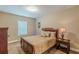Cozy bedroom featuring a wooden bed frame, side table, and carpet flooring at 3202 Lucky Pl, Conyers, GA 30013