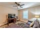 This bonus bedroom boasts a dark loveseat and ceiling fan at 3202 Lucky Pl, Conyers, GA 30013