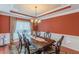 Bright dining room showcasing a wooden table, chandelier, and window with natural light at 3202 Lucky Pl, Conyers, GA 30013