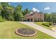 Brick home with long driveway, attached two-car garage and lush green lawn at 3202 Lucky Pl, Conyers, GA 30013