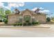 Exterior view of a brick building featuring arched windows and manicured landscaping around a circular driveway at 3202 Lucky Pl, Conyers, GA 30013