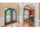 Elegant foyer with hardwood floors, decorative glass doors, and arched doorway into the dining room at 3202 Lucky Pl, Conyers, GA 30013