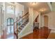 Grand foyer showcasing hardwood floors, staircase, and arched entryways at 3202 Lucky Pl, Conyers, GA 30013
