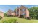 Brick home with green lawn, manicured bushes, and traditional architectural details, creating a welcoming curb appeal at 3202 Lucky Pl, Conyers, GA 30013