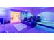 Home theater with projector, screen, tiered seating, and atmospheric lighting for immersive experience at 3202 Lucky Pl, Conyers, GA 30013