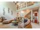 Spacious living room features a two-story ceiling, large sofa, and elegant decor at 3202 Lucky Pl, Conyers, GA 30013