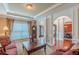 Elegant living room featuring a decorative ceiling, archways, and views into the foyer and dining room at 3202 Lucky Pl, Conyers, GA 30013