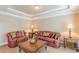 Cozy living room with plush seating, tray ceiling, and elegant decor for a comfortable atmosphere at 3202 Lucky Pl, Conyers, GA 30013