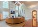 Living room with tall windows, fireplace and large sectional sofa at 3202 Lucky Pl, Conyers, GA 30013