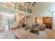 Bright living room boasts a soaring ceiling, hardwood floors, and flows into the kitchen at 3202 Lucky Pl, Conyers, GA 30013