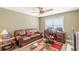 Home office features a traditional desk and chair, leather couch, and colorful area rug at 3202 Lucky Pl, Conyers, GA 30013