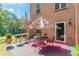 Patio with an umbrella, grill and table set, next to a brick home and green backyard at 3202 Lucky Pl, Conyers, GA 30013