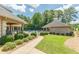 Community pool area featuring covered seating and a brick pool house, surrounded by lush greenery at 3202 Lucky Pl, Conyers, GA 30013