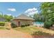Community pool area with brick pool house and manicured shrubs, a relaxing amenity for residents at 3202 Lucky Pl, Conyers, GA 30013