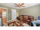 Comfortable sitting area with leather couch, colorful rug and ceiling fan; a cozy and inviting space at 3202 Lucky Pl, Conyers, GA 30013