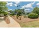 Community tennis court with well-maintained landscaping and lighting for evening play at 3202 Lucky Pl, Conyers, GA 30013