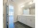 Bright bathroom with double vanity, sleek lighting, and modern black tile flooring at 1979 Deco Dr, Kennesaw, GA 30144