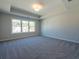 Bedroom with tray ceiling, large windows, plush carpet, and great natural light at 1979 Deco Dr, Kennesaw, GA 30144
