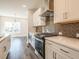 Modern kitchen with stainless steel appliances, gray backsplash, and white countertops at 1979 Deco Dr, Kennesaw, GA 30144