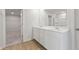 Bathroom with double sink vanity and view into the walk-in closet at 2529 Brown Dove Way (Lot 80), Grayson, GA 30017
