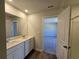 Bright bathroom features a double sink vanity with white cabinets and wood-look floors at 2539 Brown Dove Way(Lot 81), Grayson, GA 30017