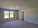 Bright bedroom with neutral walls, plush carpet, and double window views to the backyard at 2539 Brown Dove Way(Lot 81), Grayson, GA 30017