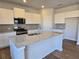 Bright kitchen features granite countertops, stainless appliances, and ample cabinet space at 2539 Brown Dove Way(Lot 81), Grayson, GA 30017