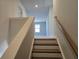 Staircase with hardwood steps and a wooden handrail leading upstairs at 2539 Brown Dove Way(Lot 81), Grayson, GA 30017