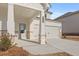 Inviting front porch with stone accents, leading to an attached two-car garage at 2519 Brown Dove Way (Lot 79), Grayson, GA 30017