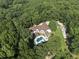 Expansive home in a private, wooded setting featuring an in-ground pool and a long, private driveway at 3355 Old Peachtree Rd, Dacula, GA 30019