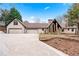 An attractive exterior shot shows a ranch-style home with a three-car garage and stone pillar accents at 3355 Old Peachtree Rd, Dacula, GA 30019