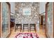 A charming foyer featuring a unique stone wall accent, hardwood floors, and glass doors at 3355 Old Peachtree Rd, Dacula, GA 30019