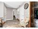 Hallway with neutral paint, wood-look floors, and views into a bedroom at 3355 Old Peachtree Rd, Dacula, GA 30019