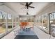 Bright sunroom with multiple ceiling fans, views of the backyard, and ample seating at 3355 Old Peachtree Rd, Dacula, GA 30019
