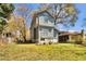 View of the home's backyard with a large grassy area and mature trees under a bright blue sky at 561 Culberson Sw St, Atlanta, GA 30310