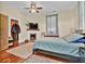 Bedroom features ceiling fan, wood floors and fireplace at 561 Culberson Sw St, Atlanta, GA 30310