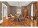 Elegant dining room with hardwood floors, a stylish chandelier, and a round area rug at 561 Culberson Sw St, Atlanta, GA 30310