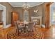 Cozy dining room with hardwood floors, round table and area rug, chandelier, and neutral paint at 561 Culberson Sw St, Atlanta, GA 30310