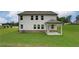 A well-maintained backyard with a covered patio and expansive green space, perfect for outdoor activities at 1797 Kingsmere Run Dr, Loganville, GA 30052