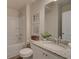 Well-lit bathroom with a granite countertop, framed artwork, and a tub-shower combination for convenience at 1797 Kingsmere Run Dr, Loganville, GA 30052