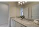 Bathroom featuring a double vanity with granite countertop and large mirror at 1797 Kingsmere Run Dr, Loganville, GA 30052