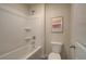 Bathroom with a white shower-tub combo, toilet, and framed artwork at 1797 Kingsmere Run Dr, Loganville, GA 30052