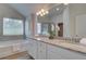 Bathroom featuring double vanity, granite counters, soaking tub, and tiled shower at 1797 Kingsmere Run Dr, Loganville, GA 30052