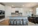 Stylish kitchen island with counter seating, granite countertops, and stainless appliances, ideal for dining and entertaining at 1797 Kingsmere Run Dr, Loganville, GA 30052