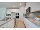 Modern kitchen featuring granite countertops, stainless steel appliances, and gray subway tile backsplash at 1797 Kingsmere Run Dr, Loganville, GA 30052