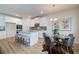 Bright kitchen features white cabinetry, granite countertops, stainless steel appliances, and an island with barstool seating at 1797 Kingsmere Run Dr, Loganville, GA 30052