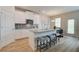 Modern kitchen featuring granite countertops, white cabinets, stainless steel appliances, and a breakfast bar at 1797 Kingsmere Run Dr, Loganville, GA 30052